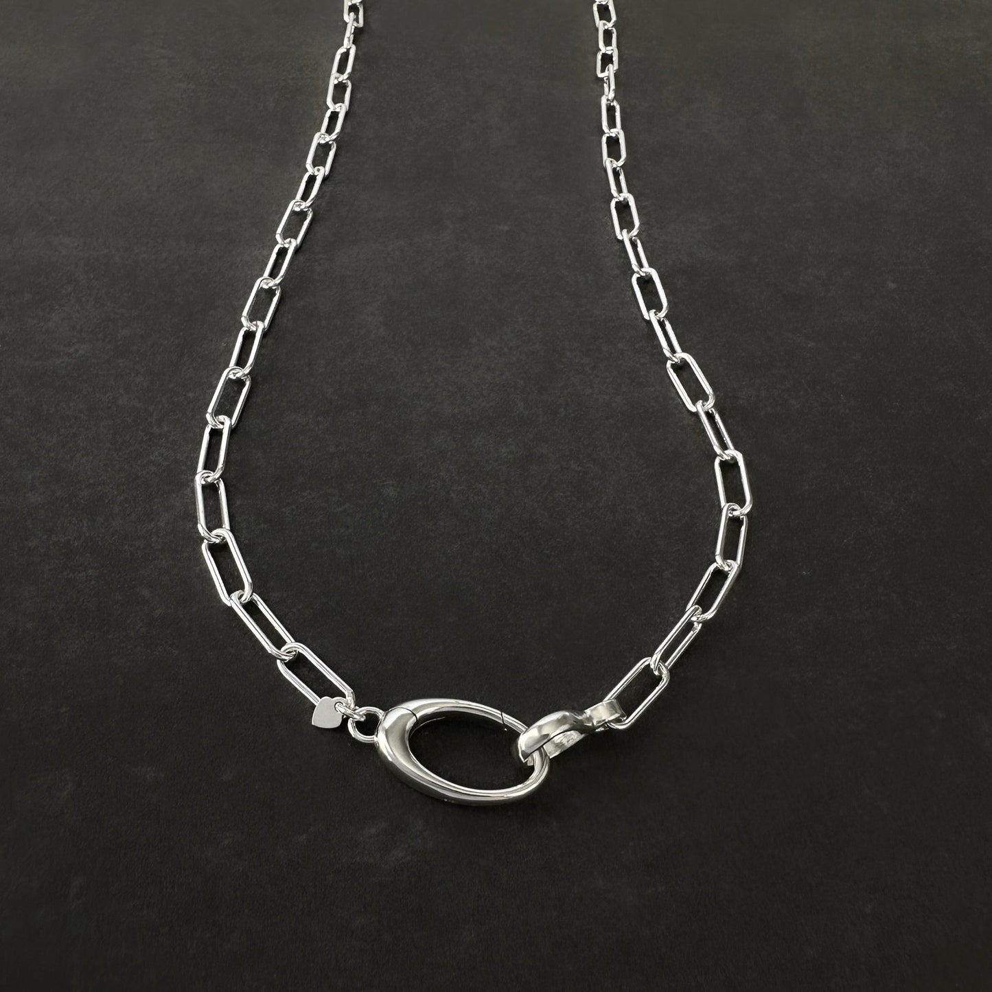 Silver chain necklace on a dark background