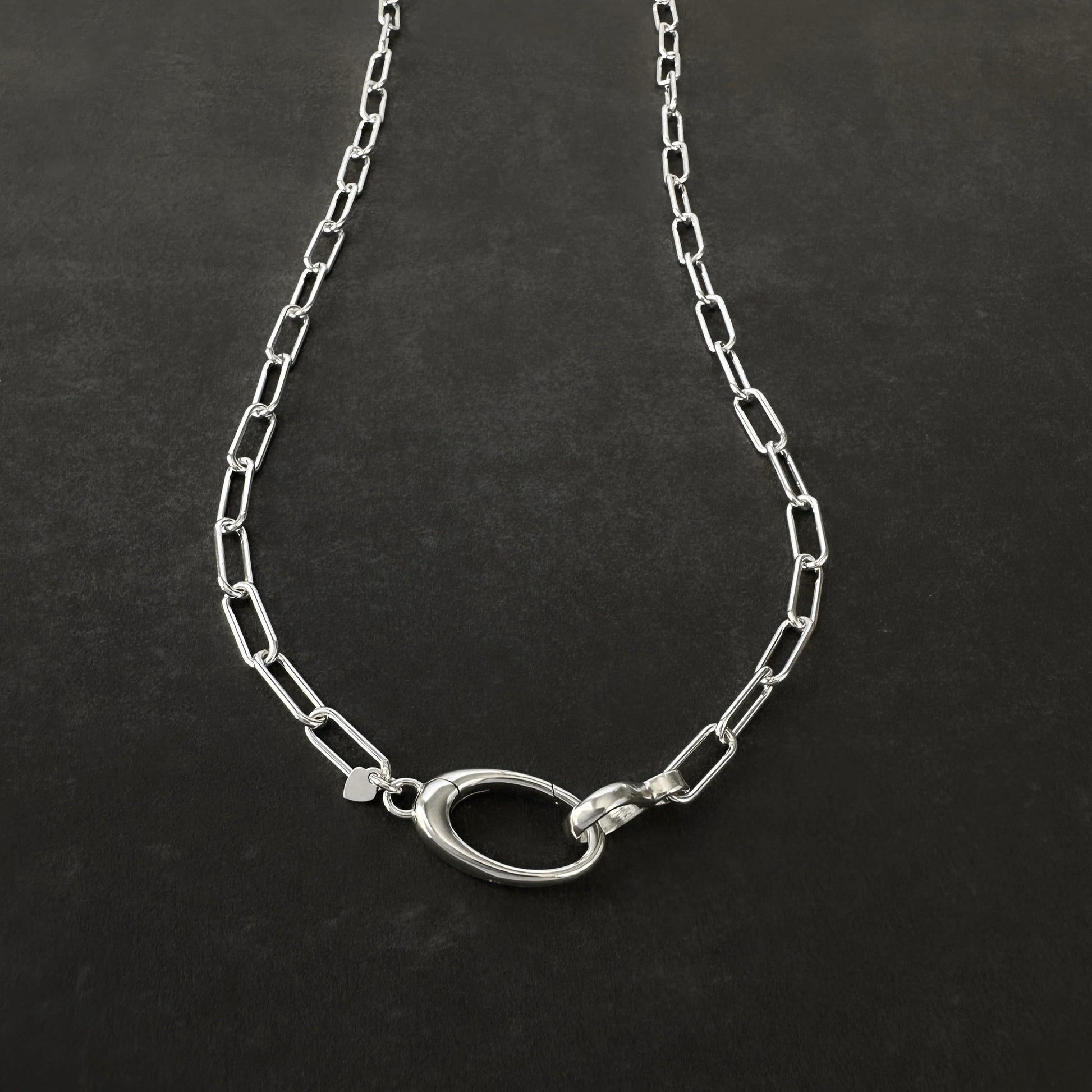 Silver chain necklace on a dark background