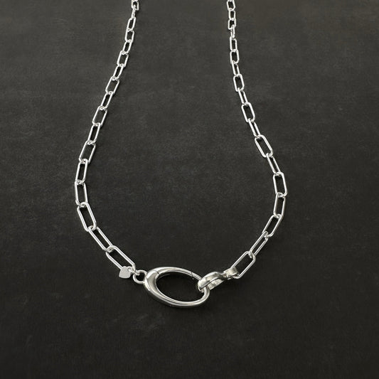 Silver chain necklace on a dark background