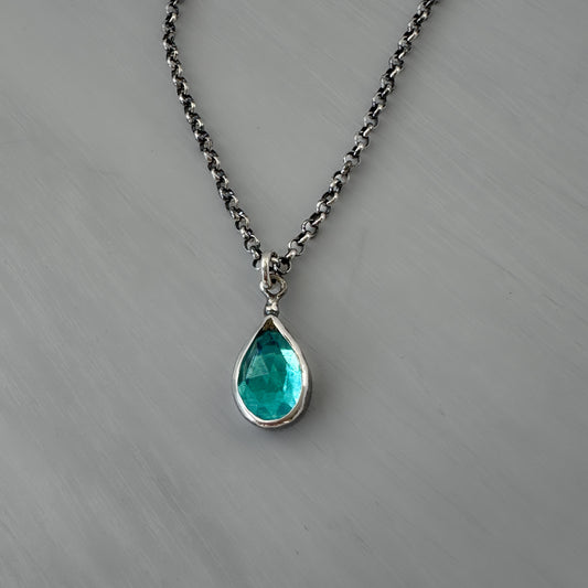 Necklace with a teardrop-shaped London blue topaz pendant on patina finished rolo chain
