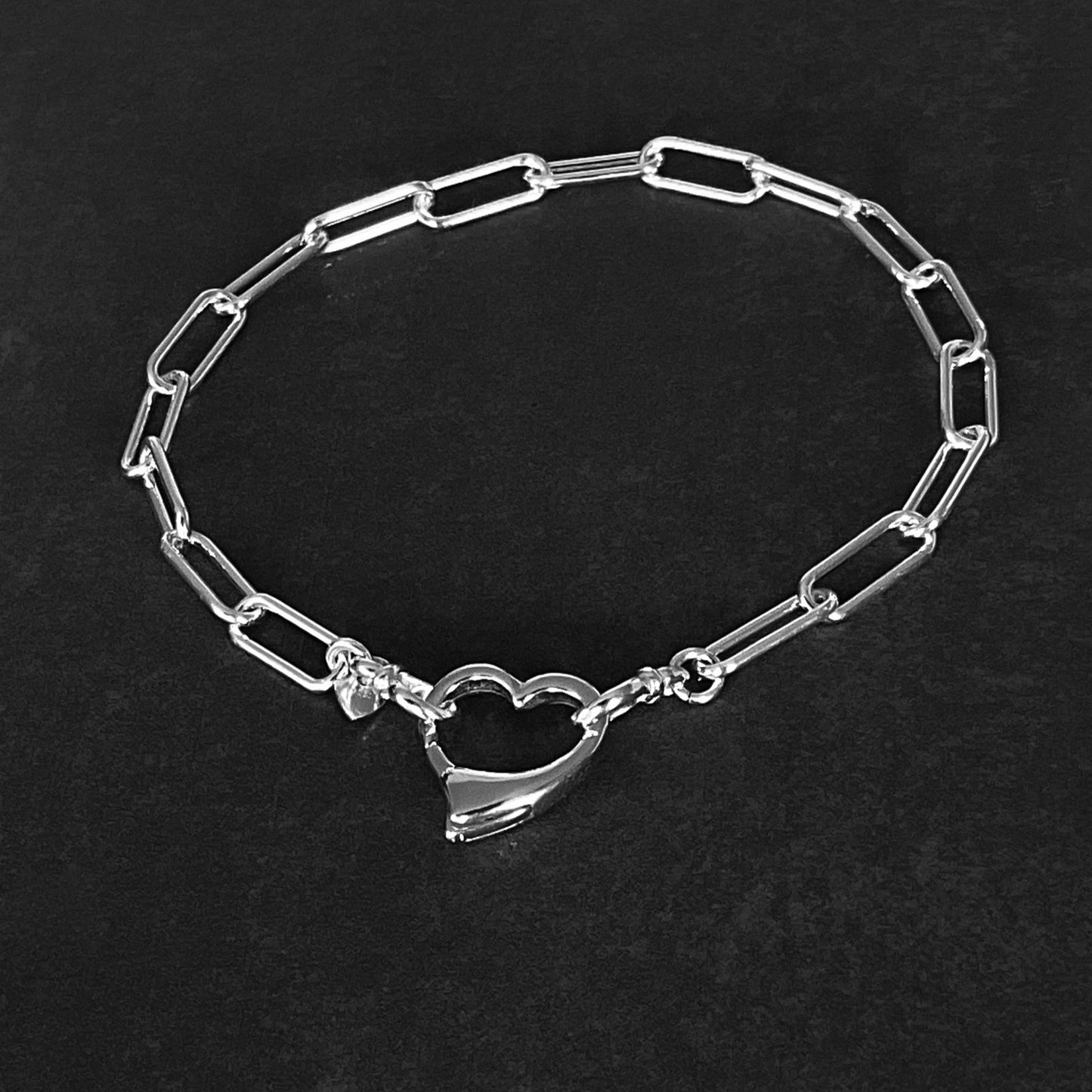 solid sterling silver paperclip chain bracelet 4.3mm with an open heart clasp 13.5mm attaches to both ends of the chain