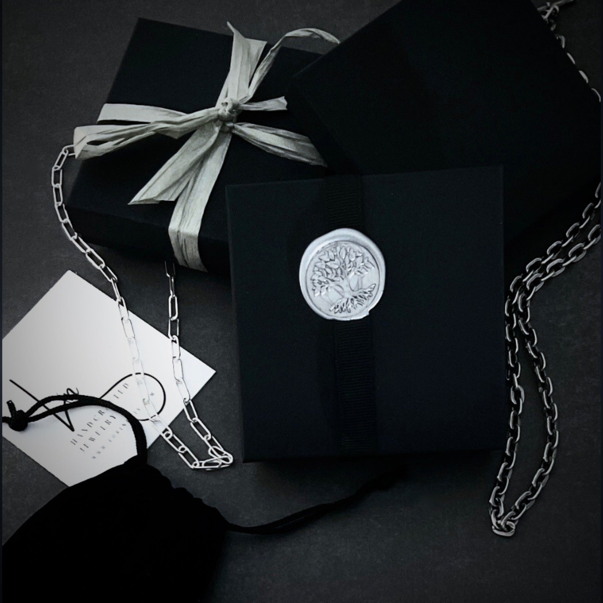 complimentary gift wrapping in this eco-friendly matte  black  jewelry gift box with a wax stamp seal and ribbon.