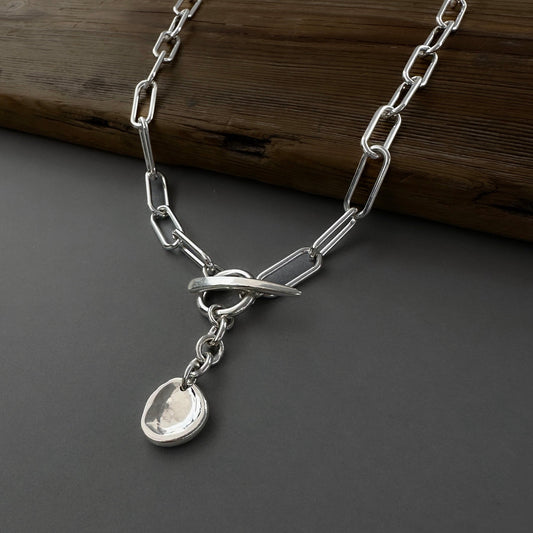 silver paperclip chain toggle clasp with coin medallion pendant
